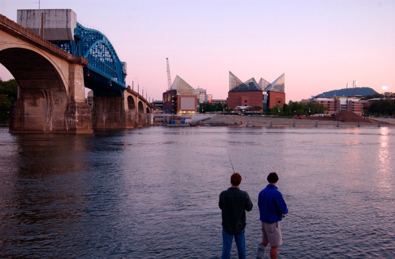 Luke Chandler, left, and Whit Dowlen fish along the north bank of the Tennessee River in downtown Chattanooga in 2005 as the city prepared to open the $120 million waterfront project. (AP/Photo Mark Gilliland)