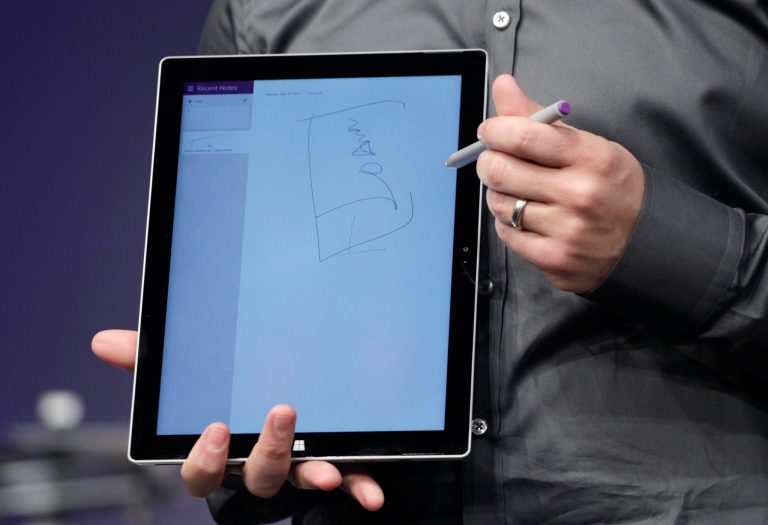 Panos Panay, Microsoft's vice president for Surface Computing, holds an electronic stylus that works with the Surface Pro 3 and Final Draft software at a media preview, Tuesday, May 20, 2014 in New York. The device will have a screen measuring 12 inches diagonally, up from 10.6 inches in previous models. Microsoft says it's also thinner and faster than before.  (AP Photo/Mark Lennihan)