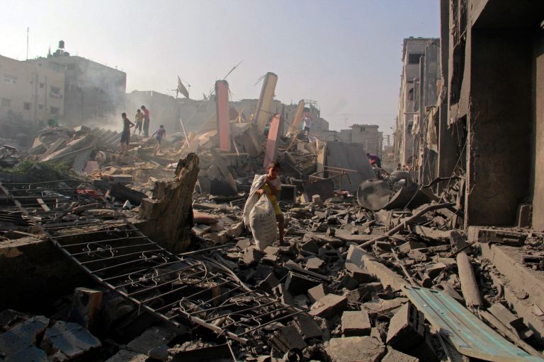 FILE - In this Aug. 2, 2014 file photo, Palestinians look for their belongings after houses were destroyed in Israeli strikes in Rafah, southern Gaza Strip. Amid fear that Hamas had captured an Israeli soldier, the Israeli military sealed off the Rafah area and began shelling on Aug. 1, 2014. By the end of the next day, 190 Palestinians were dead, according to a list of names compiled by two Gaza human rights groups. The suspected capture of the soldier turned out to be a false alarm and the Rafah operation is almost certain to be a focus of U.N. investigators and rights groups looking into possible war crimes because it highlights a key concern: The treatment of civilians. (AP Photo/Hatem Ali, File)