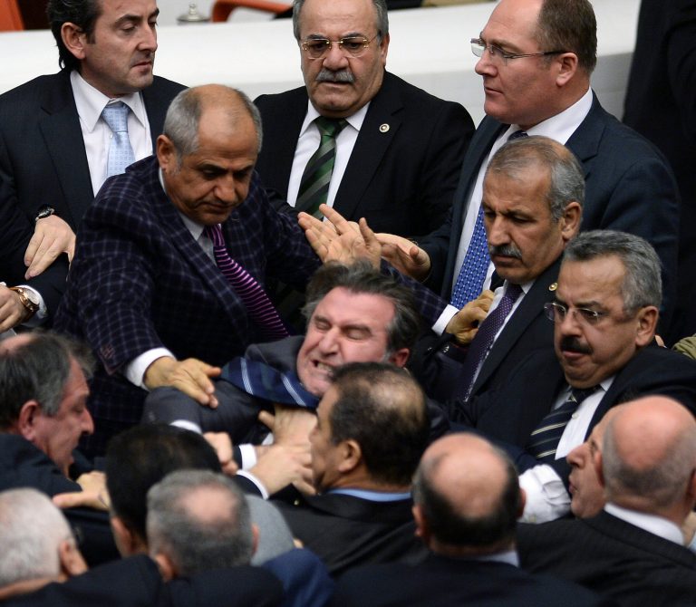Turkish legislators from Prime Minister Recep Tayyip Erdogan's ruling party and the main opposition Republican People's Party brawl during a tense all-night debate over a controversial law on changes to a council that appoints and overseas judges and prosecutors, in Ankara, early Saturday, Feb. 15, 2014. One legislator suffered a broken finger while another suffered a nose-bleed. Opposition parties say the bill would give the government wider controls over the council. (AP Photo)