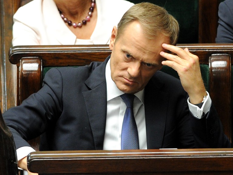 Polish Prime Minister Donald Tusk listens to lawmakers in the parliament in Warsaw, Poland, Wednesday, June 25, 2014. Tusk asked lawmakers for an urgent confidence vote in his government, which has been rocked by leaking tapes of private conversations of top state officials. (AP Photo/Alik Keplicz)