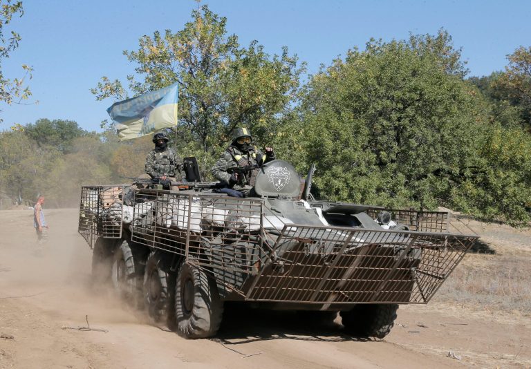 Ukrainian army paratroopers sit atop the APC as they move to position inin Debaltsevo, Donetsk's region, Ukraine, Thursday, Sept. 18, 2014. The cease-fire between the separatists and the Ukrainian military in eastern Ukraine has largely held. (AP Photo/Efrrem Lukatsky)