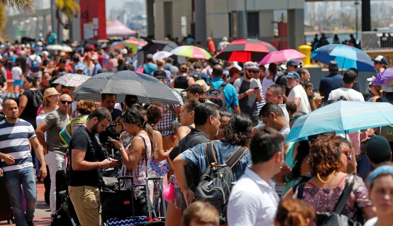 The aftermath of the powerful storm has resulted in a near-total shutdown of the U.S. territory's economy that could last for weeks and has many people running seriously low on cash and worrying that it will become even harder to survive on this hurricane-ravaged island. (AP Photo/Gerald Herbert)