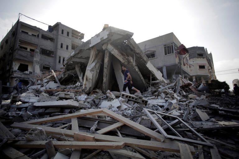 A Palestinian walks amid the rubble of a destroyed house after it was hit by an Israeli strike in Gaza City, Monday, Aug. 25, 2014. (AP Photo/Khalil Hamra)