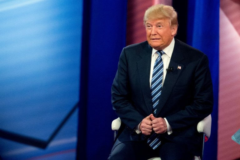 Larry Elder asked why he's never seen Donald Trump button his suit jacket. To which Roger Stone replied, 