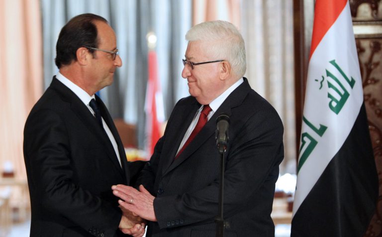 French President Francois Hollande, left, shakes hands with his Iraqi counterpart President Fouad Massoum during their joint news conference in Baghdad on Friday, Sept. 12, 2014. Hollande expressed his solidarity with Iraq on a visit to Baghdad on Friday, as his country prepares for possible airstrikes with a U.S.-led coalition against extremists who have seized territory around the region. (AP Photo/Ali al-Saadi, Pool)