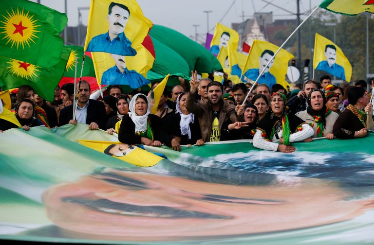 Some thousand Kurds protest against the Islamic State militants attack on the Syrian city Kobani with a flag showing Kurdistan Workers' Party imprisoned leader Abdullah Ocalan in Duesseldorf, Germany, Saturday, Oct. 11, 2014.(AP Photo/Frank Augstein)