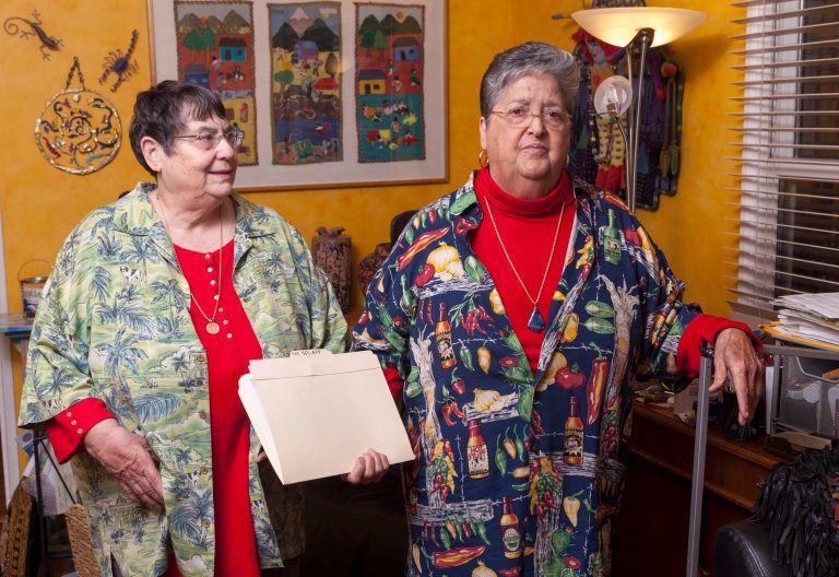 In this Friday, March 8, 2013 photo, married couple Sharon Raphael, left, and Mina Meyer hold their Social Security papers at their home in Long Beach, Calif. Accountants and attorneys are encouraging married same-sex couples to apply now for retroactive tax refunds and Social Security benefits in anticipation of the Supreme Court possibly overturning a federal law that prevents the federal government from recognizing gay and lesbian unions. The high court will hear arguments this month on the constitutionality of the Defense of Marriage Act, which makes same-sex couples ineligible for filing joint tax returns or receiving survivor payments in the event of a spouse's death. (AP Photo/Damian Dovarganes)