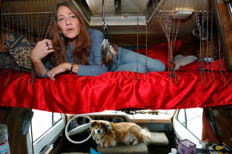 FILE - This June 4, 2008 photo shows Darlene Knoll, 53, resting in the sleeping area of the battered 1978 motor home where she lives in Los Angeles. A federal appeals court on Thursday, June 19, 2014, struck down a 31-year-old Los Angeles law that bars people from living in parked vehicles, saying the vaguely written statute discriminates against homeless and poor people. (AP Photo/Damian Dovarganes, file)