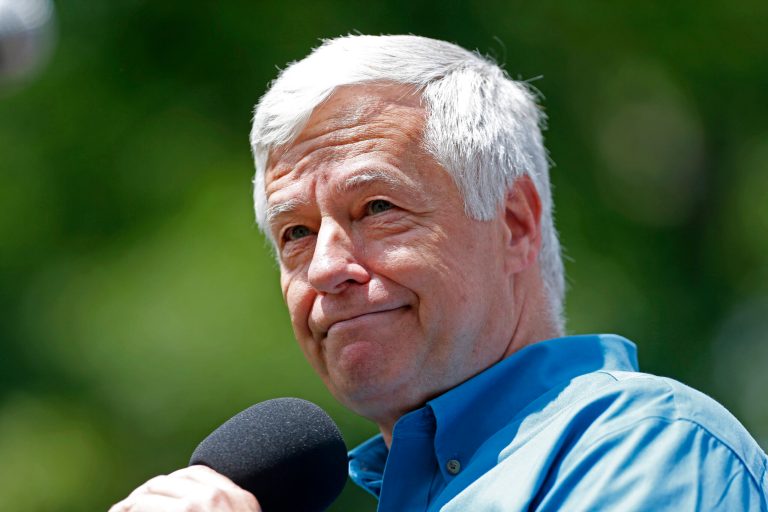 U.S. Rep. Mike Michaud, a Democratic candidate for governor, acknowledges applause while speaking at a rally following the Portland Pride Parade, Saturday, June 21, 2014, in Portland, Maine. (AP Photo/Robert F. Bukaty)