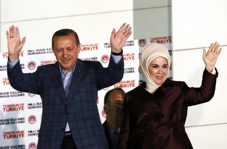Turkish Prime Minister Recep Tayyip Erdogan and his wife Emine Erdogan acknowledge supporters after Erdogan's election victory, in Ankara, Turkey, Sunday, Aug. 10, 2014. Erdogan won Turkey's first direct presidential election Sunday, striking a conciliatory tone toward critics who fear he is bent on a power grab as he embarks on another five years at the country's helm.(AP Photo/Burhan Ozbilici)