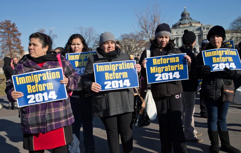 Immigration activists gather on Capitol Hill in Washington, Thursday, Dec. 12, 2013, as lawmakers speak on the steps of the House of Representatives to appeal for action on an immigration reform bill. A reform bill that could provide a pathway to citizenship for the roughly 11 million immigrants living illegally in the United States has languished as the House Republican leadership has not put the bill to a vote before the holiday recess. (AP Photo/J. Scott Applewhite)
