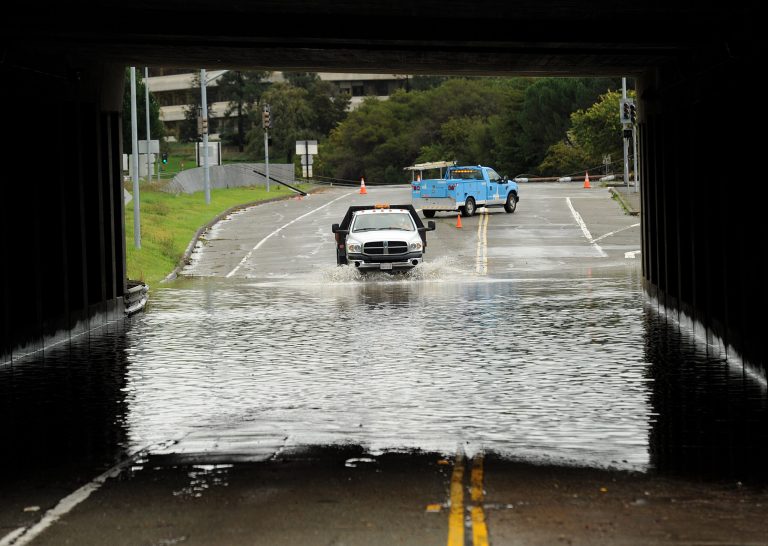   A traffic control vehicle transits a flooded underpass in San Rafael, Calif., on Sunday, Dec. 2, 2012. Days of heavy rains have left the region saturated and several rivers are expected to flood their banks Sunday afternoon. (AP Photo/Noah Berger)  