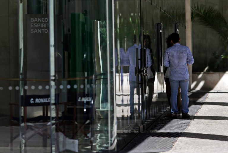 A couple withdraw money from an ATM at the Portuguese bank Banco Espirito Santo's headquarters in Lisbon, Friday, July 11, 2014. Senior Portuguese officials gave assurances Friday about the soundness of Portugal's biggest bank, seeking to defuse tension after world markets went into a spin over fears that Banco Espirito Santo's troubles could reignite Europe's financial difficulties. (AP Photo/Francisco Seco)