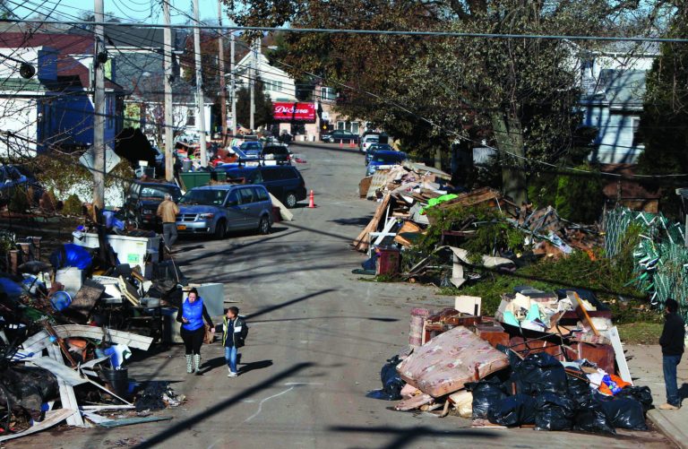 Garbage lies piled on the street in the New Dorp neighborhood of Staten Island, N.Y., Sunday, Nov. 4, 2012, in the aftermath of Superstorm Sandy. (AP Photo/Seth Wenig)