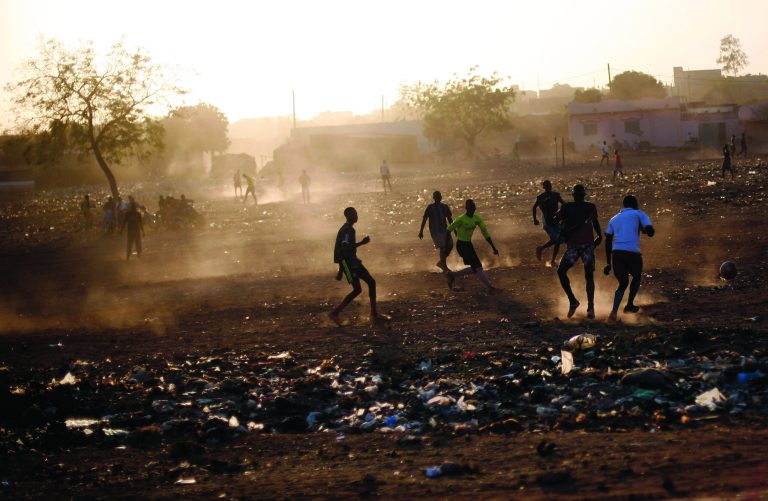 Young men play football in Bamako, Mali, Tuesday Jan. 15, 2013. French forces led an all-night aerial bombing campaign Tuesday to wrest control of a small Malian town from armed Islamist extremists who seized the area, including its strategic military camp. A a convoy of 40 to 50 trucks carrying French troops crossed into Mali from Ivory Coast as France prepares for a possible land assault. Several thousand soldiers from the nations neighboring Mali are also expected to begin arriving in coming days. (AP Photo/Jerome Delay)