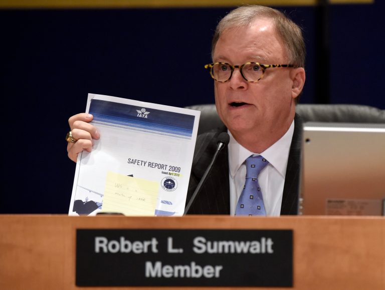 National Transportation Safety Board (NTSB) member Robert Sumwalt holds up a document during a hearing at the NTSB in Washington, Tuesday, Sept. 9, 2014. The NTSB was meeting to discuss UPS Flight 1354 plane crash. The UPS plane, an Airbus A300-600F, crashed shortly before dawn on Aug. 14, 2013, as it was preparing to land in Birmingham. It hit trees and a utility pole before slamming into a hillside and bursting into flames. (AP Photo/Susan Walsh)