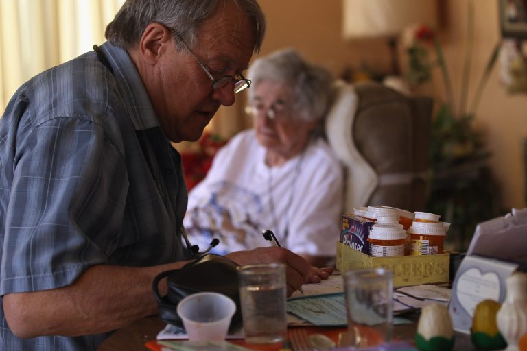 DENVER, CO - MARCH 23:  Registered nurse Steve Van Dyke takes notes while paying a house call to patient Mildred Herman, 91, on March 23, 2012 in Denver, Colorado. Van Dyke works for the Dominican Sisters Home Health Agency, a non-profit that performs thousands of home visits each year for needy patients, most without private health insurance. The agency provides home health care without charge to people with chronic diseases and gives preventative services that are often not covered by Medicare.  (Photo by John Moore/Getty Images)