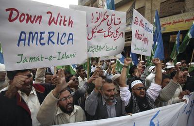 Supporters of Pakistani religious party Jamaat-i-Islami rally to condemn NATO airstrikes on Pakistani troops, on Friday, Dec 2, 2011 in Peshawar, Pakistan. Confusion and a communication breakdown prevented Pakistan's airforce from scrambling to defend troops on the ground during the deadly NATO bombing last weekend of two border outposts, the military said Friday, responding to rare domestic criticism of the powerful institution. A placrad in center reads