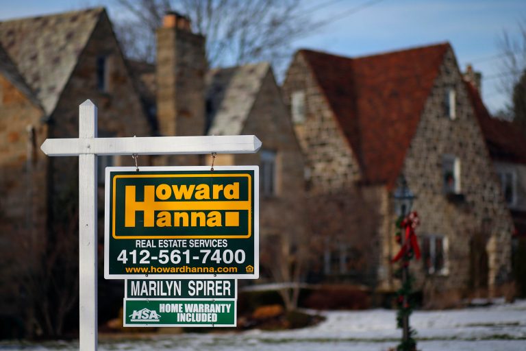 In this Thursday, Jan. 9, 2014, photo, a for sale sign hangs in front of a house in Mount Lebanon, Pa. The National Association of Realtors releases existing home sales for December, on Thursday, Jan. 23, 2014. (AP Photo/Gene J. Puskar)