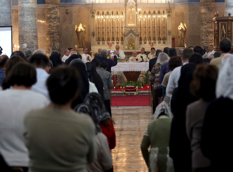 Iraqi Christians attend a Mass at a church in Baghdad. Middle East Christians face repeated violence by militants of the Islamic State group. (AP Photo/Karim Kadim)
