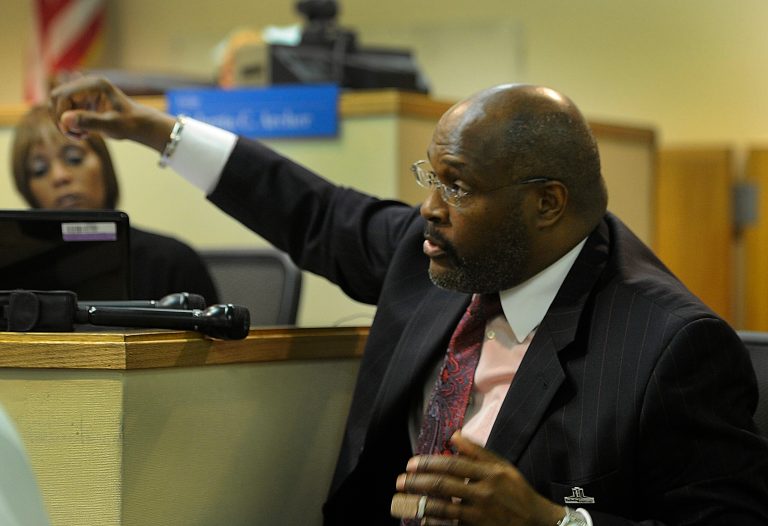   Pastor Marvin Winans demonstrates how he was punched and beaten during the attack at the Citgo gas station during his testimony at the 36th District Court in Detroit, on Monday, June 11, 2012. Brian Young, 18 of Clinton Township, Montoya Givens, 20 and Christopher Moorhead, 20, both of Detroit, appeared for a preliminary examination for carjacking, unarmed robber and conspiracy against Pastor Winans at the gas station last month. (AP Photo/The Detroit News, Daniel Mears)  