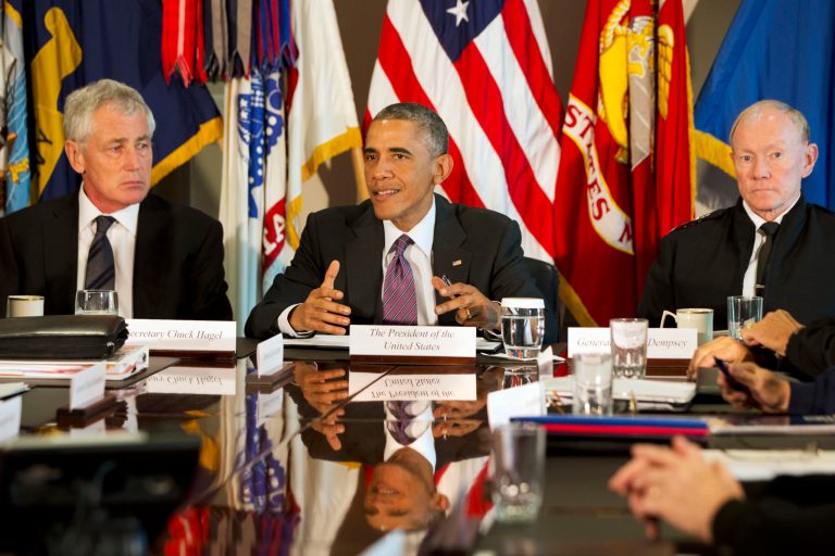 President Barack Obama, flanked by Defense Secretary Chuck Hagel, left, and Joint Chiefs Chairman Gen. Martin Dempsey, speaks to the media at the conclusion of a meeting with senior military leadership, Wednesday, Oct. 8, 2014, at the Pentagon. (AP Photo/Jacquelyn Martin)