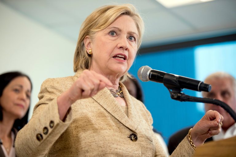 Hillary Clinton touted her work alongside former Utah Gov. Jon Huntsman, and encouraged Utahns to heed the words of 2012 GOP nominee Mitt Romney, who blasted Donald Trump's religious ban proposals. (AP Photo)