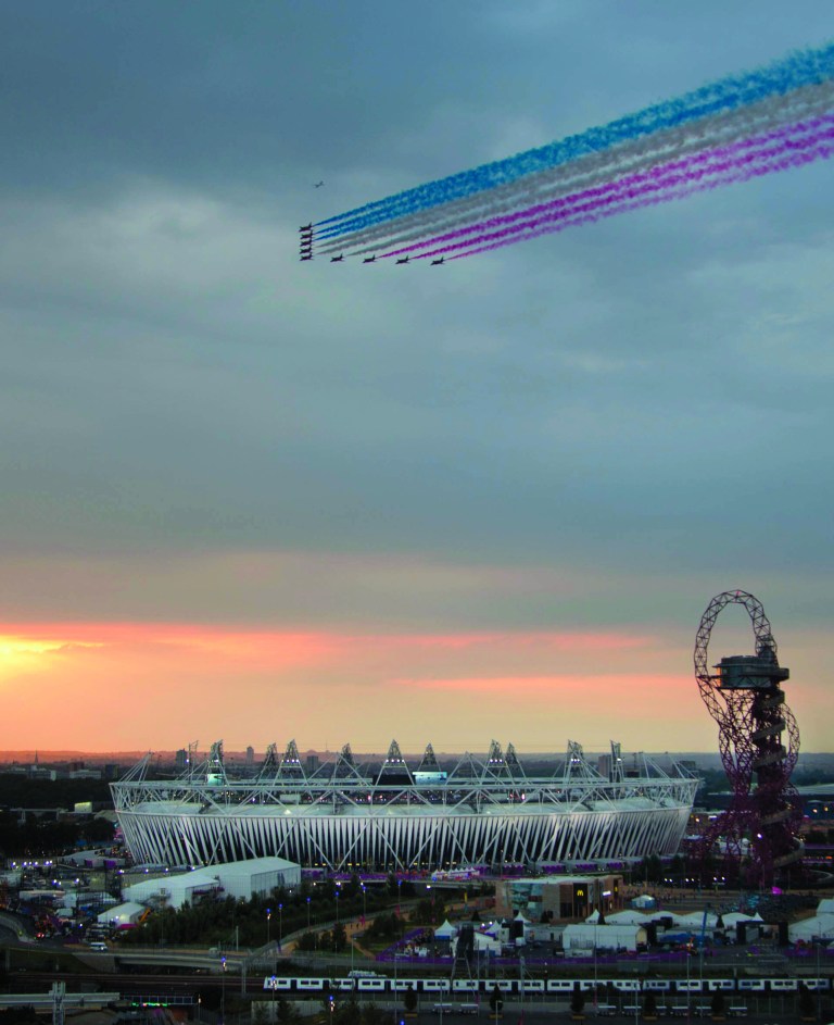 Ben Curtis/AP
The Red Arrows aerobatic team flies over the Olympic Stadium ahead of the Opening Ceremony of the 2012 Summer Olympics, Friday in London.