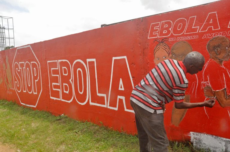 A local Liberian artist paints a mural forming part of the country's fight against the deadly Ebola virus by education in the city of Monrovia, Liberia, Tuesday, Sept. 23, 2014. U.S. health officials Tuesday presented worst-case and best-case scenarios for the Ebola epidemic in West Africa, calculating that as many as 1.4 million people could be sickened in two countries alone by mid-January _ or the outbreak could be winding down by then, if control efforts substantially increase. (AP Photo/Abbas Dulleh)
