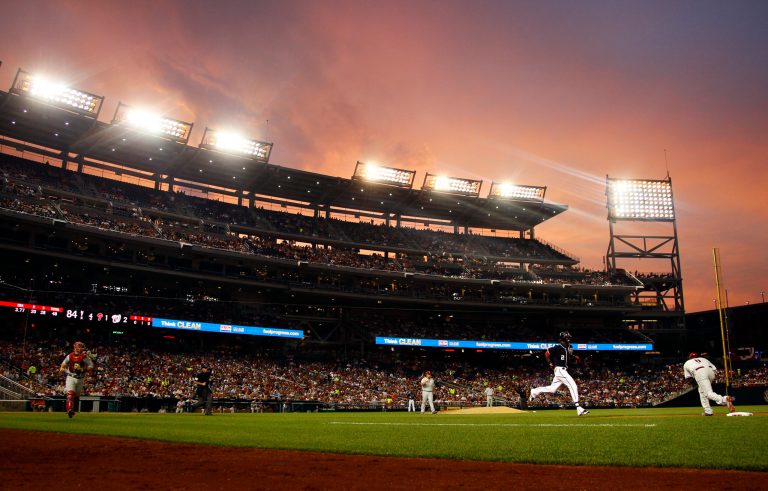 The sky glows over Nationals Park as the sun sets in the fourth inning of a baseball game between the Washington Nationals and Philadelphia Phillies, Wednesday, Aug. 1, 2012, in Washington. The Phillies won 3-2. (AP Photo/Carolyn Kaster)