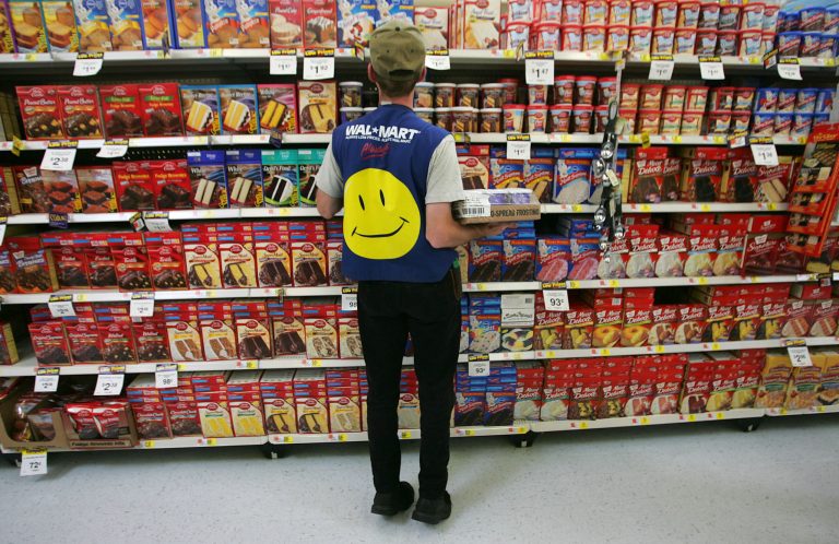 An employee restocks a shelf in the grocery section of a Wal-Mart Supercenter May 11, 2005 in Troy, Ohio. (Photo by Chris Hondros/Getty Images)