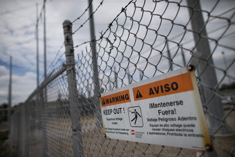 A barbed wire fence surrounds an AEP electrical transmission substation in Westerville, Ohio. (AP Photo/John Minchillo)