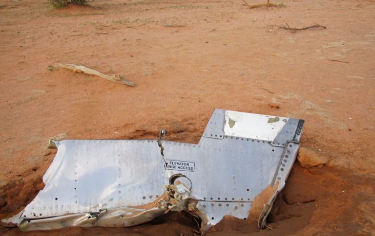 This photo provided on Friday, July 25, 2014,  by the Burkina Faso Military shows a part of the plane at the crash site,  in Mali. French soldiers secured a black box from the Air Algerie wreckage site in a desolate region of restive northern Mali on Friday, the French president said. Terrorism hasn't been ruled out as a cause, although officials say the most likely reason for the catastrophe that killed all onboard is bad weather. At least 116 people were killed in Thursday's disaster, nearly half of whom were French. (AP Photo/Burkina Faso Military)