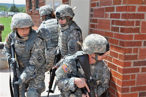In this June 8, 2012 photo provided by the South Dakota National Guard, members of the South Dakota Army National Guard's 129th Mobile Public Affairs Detachment, of Rapid City, N.D., practice tactical movement procedures at Camp Rapid. The Pentagon's announcement lifting the ban on women in combat units will affect the South Dakota National Guard.  Records show that 36 women currently serving in the South Dakota National Guard have earned combat action badges, a token issued to soldiers that have been in combat.  (AP Photo/South Dakota National Guar, Sgt. Andrew Turner)