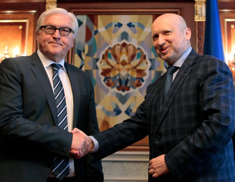 German Foreign Minister Frank-Walter Steinmeier, left, shakes hands with acting Ukrainian President Oleksandr Turchynov during a meeting in Kiev, Ukraine, Tuesday, May 13, 2014. Steinmeier flew to Ukraine Tuesday to help start talks between the Ukrainian government and its foes following the declaration of independence by two eastern region. (AP Photo/Sergei Chuzavkov)