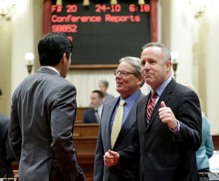 State Senate President Pro Tem Darrell Steinberg, D-Sacramento, right, pumps his fist after the Senate approved the state budget at the Capitol in Sacramento, Calif., Sunday, June 15, 2014. Lawmakers faced a Sunday deadline to pass the $108 billion spending plan that meets Gov. Jerry Brown's demand for a rainy day fund and paying down debt while allocating some of the surplus to programs benefiting lower-income Californians.(AP Photo/Rich Pedroncelli)