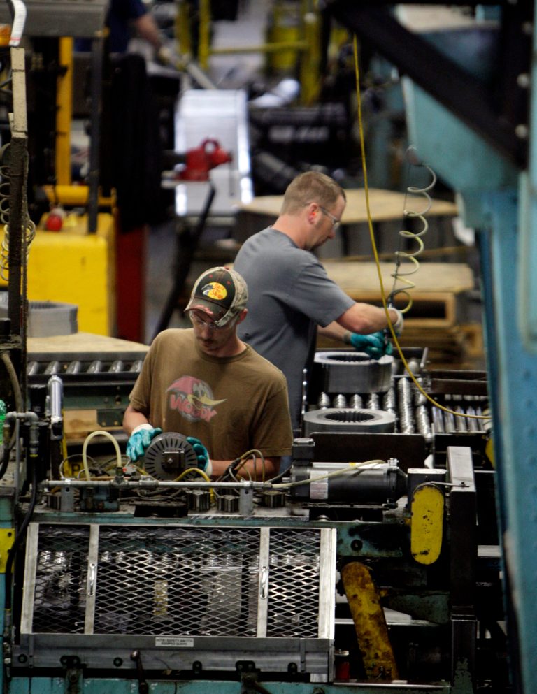 FILE - In this June 3, 2009 file photo, Baldor Electric Co. employees Dave Johnston, left, and Steve Davis, right, work inside the company's factory in St. Louis. The government issues its second of three estimates of how fast the U.S. economy grew in the January-March quarter later Thursday May 29, 2014. (AP Photo/Jeff Roberson, File)