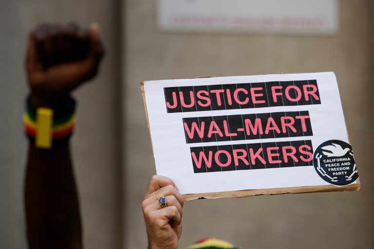 Several warehouse workers marched through a northwestern Indiana Walmart store as they protested what they called freezing work conditions. (AP/Jae C. Hong)
