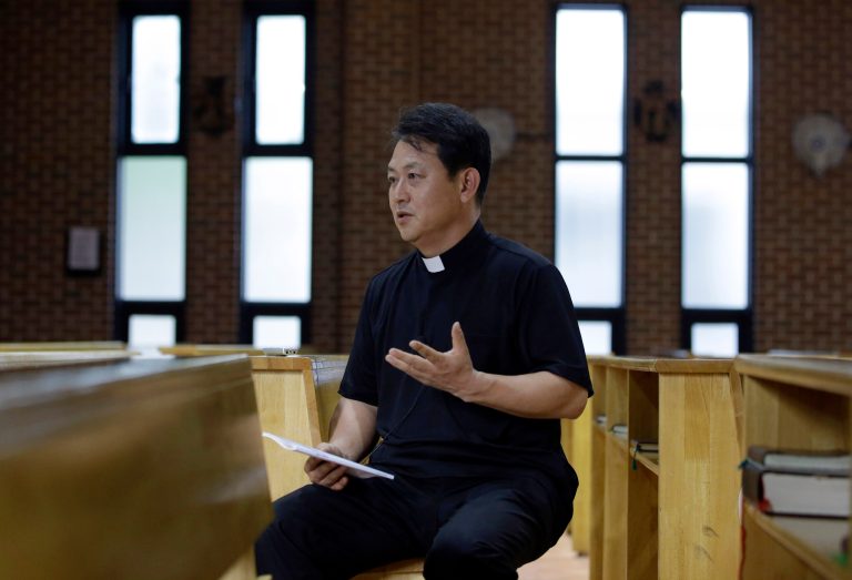 HOLD FOR USE WITH STORY SLUGGED SOUTH KOREA POPE MARTYRS BY  HYUNG-JIN KIM, The Rev. Park Geun Tae speaks to a reporter during an interview at a Seoul Catholic church in Seoul, South Korea, Monday, July 28, 2014. (AP Photo/Lee Jin-man)