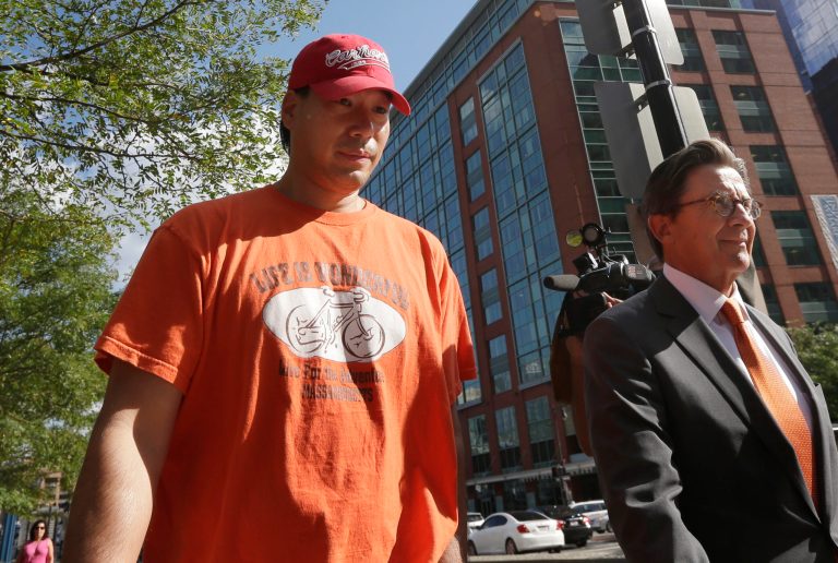 Glenn Adam Chin, left, a former supervisory pharmacist at the New England Compounding Center, walks with his attorney Paul Shaw, right, after appearing in federal court, Thursday, Sept. 4, 2014, in Boston. The pharmacy, which custom-mixed medications in bulk, has been blamed for a 2012 outbreak of fungal meningitis that killed 64 people. Chin was charged with one count of mail fraud, but federal prosecutors said it is part of a larger criminal investigation of Chin and others. (AP Photo/Steven Senne)