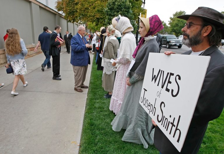 Street preacher Jerry Holt and several of his followers stand in protest to try inform Mormons of the many wives of Mormon founder Joseph Smith. (George Frey/Getty Images)