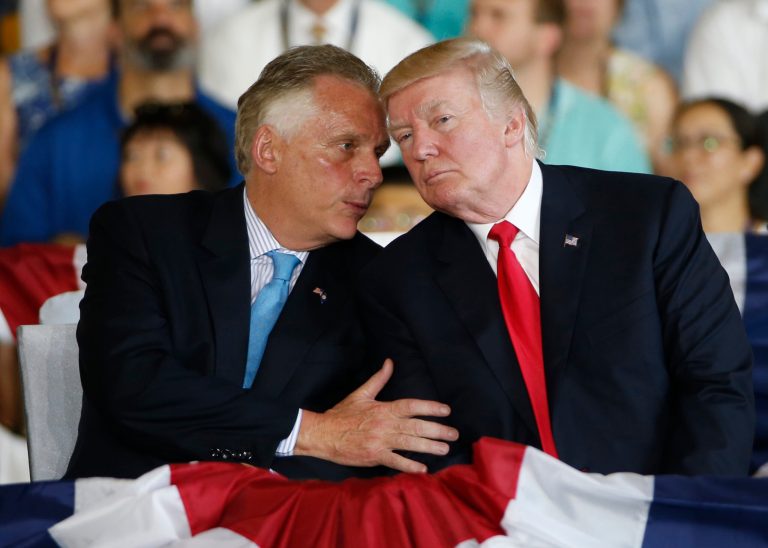 President Donald Trump, right, talks with Virginia Gov. Terry McAuliffe during commissioning ceremonies aboard the nuclear aircraft carrier USS Gerald R. Ford at Naval Station Norfolk in Norfolk, Va., Saturday, July 22, 2017. (AP Photo/Steve Helber)