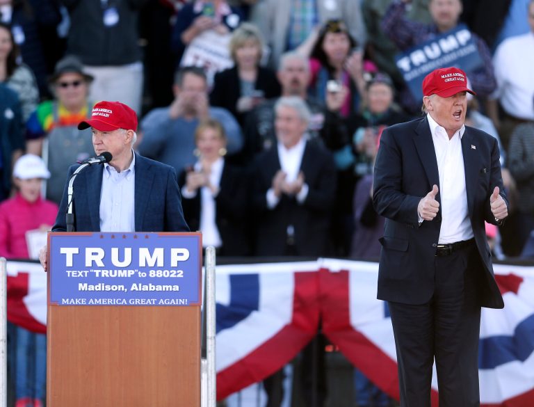 Republican presidential candidate Donald Trump, right, gestures as Sen. Jeff Sessions, R-Ala., speaks during a rally Sunday, Feb. 28, 2016, in Madison, Ala. (AP Photo/John Bazemore)