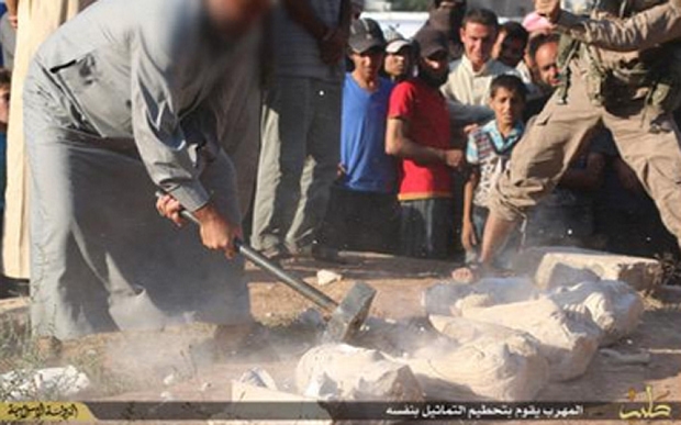Jihadis took sledgehammers to the relics, smashed them to pieces and then lashed the man who allegedly smuggled the artifacts in a public square full of onlookers, the Islamic State announced Thursday. (Screenshot from Islamic State propaganda video)