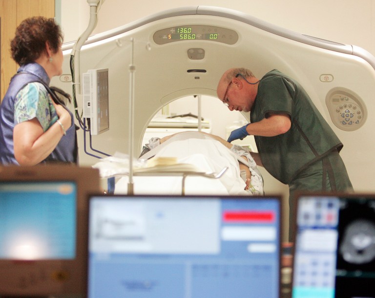 Dr. Steven Birnbaum works with a patient in a CT scanner at Southern New Hampshire Medical Center in Nashua, N.H. (AP/Jim Cole)
