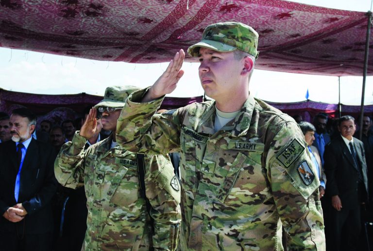 U.S. soldiers, part of the NATO- led International Security Assistance Force (ISAF) salute during a hand over ceremony of U.S.- run prison to Afghan government in Bagram north of Kabul, Afghanistan, Monday, Sept. 10, 2012. U.S. officials handed over formal control of Afghanistan's only large-scale U.S.-run prison to Kabul on Monday, even as disagreements between the two countries over the thousands of Taliban and terror suspects held there marred the transfer. (AP Photo/Musadeq Sadeq)