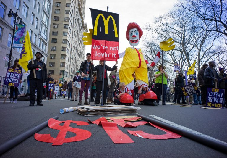 People gather during a protest as participants, fast food workers and union members, call for a $15 minimum wage in New York, Wednesday, April 15, 2015. (AP Photo/Craig Ruttle)