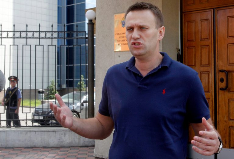   Anti-corruption blogger Alexei Navalny speaks to the media as he arrives for questioning at the headquarters of the Russian Investigation committee in Moscow, Russia, Wednesday, June 13, 2012. (AP Photo/Misha Japaridze)  