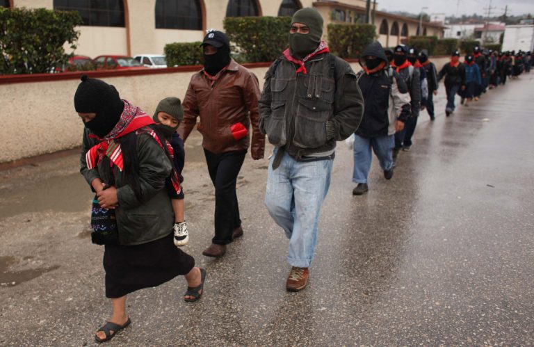   Masked Mayan Indians who are members of the Zapatista National Liberation Army (EZLN) march in line to the mayor's office in San Cristobal de las Casas, Chiapas state, Mexico, Friday, Dec. 21, 2012. On Friday, Zapatistas in several cities are marching to the city mayor's office for a gathering where they will listen to a message from their leaders. (AP Photo/Ivan Castaneira)  